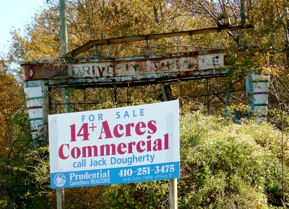 FUTURE ON HOLD: There's a bright new sign in front of the wreckage of the old drive-in movie sign. The 14 acres where folks once enjoyed movies outdoors on summer evenings, that real estate is still here. 